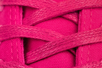 Extreme close up of cyclamen sneaker with cyclamen laces.