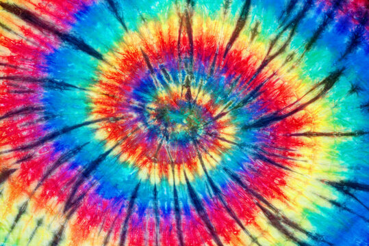 spiral tie dye pattern hand dyed on cotton fabric abstract texture background.