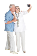 portrait of happy senior couple taking selfie