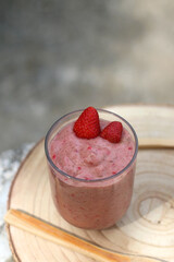 Banana and berry nice cream, served in a garden. Selective focus.