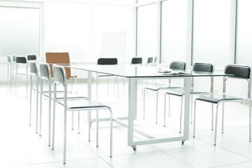 Flipchart chairs and glass table in a bright office space