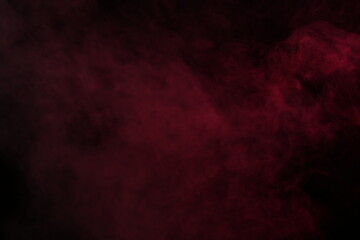 Obraz na płótnie Canvas Artificial magic smoke in red light on black background