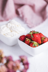 Strawberries with mascarpone cream decorated with flower and purple towel