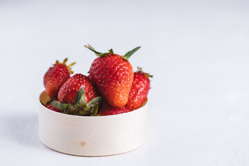 Fresh strawberries in metal cup on a white background isolated