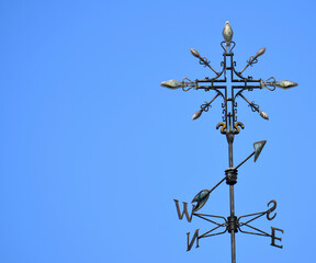 Fototapeta na wymiar Metal compass in sunny blue sky