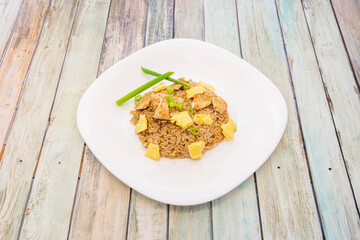 chaufa-style rice with diced French omelet, chicken pieces and vegetables