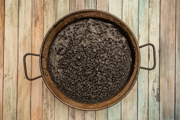 Spanish paella of delicious rice dyed black with squid ink