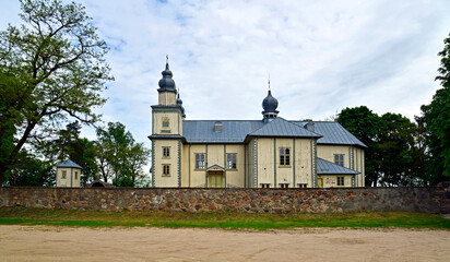 The wooden Catholic church of Saint John the Baptist was built with the belfry in 1871 in Turośl in Podlasie, Poland. The photos also show architectural details.