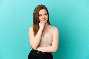 Teenager girl over isolated blue background having doubts and thinking