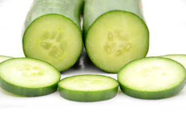 closeup the pair of sliced green ripe cucumber isolated on white background.