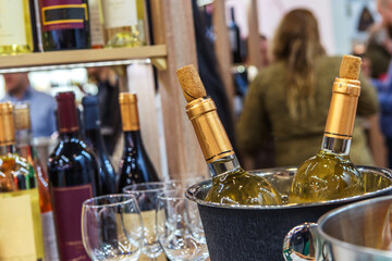 Bottled wine is cooled in a metal bucket. Tasting of alcoholic beverages in a small restaurant. Foreground