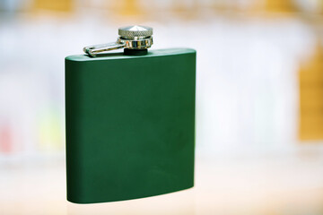 Small green flask for alcoholic beverages. Copy space