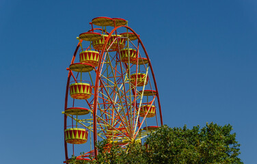 Fototapeta premium Ferris wheel side view on sky background