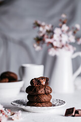 Chocolate lava cakes served on a white wooden board decorated with blossom flowers