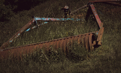 Abandoned Harrow rusting in a field