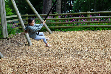 child playing on zip swing