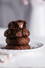 Chocolate lava cakes served on a white wooden board decorated with blossom flowers