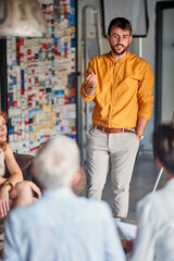 A young businessman is talking to his colleagues during a presentation at workplace. Business, office, job