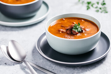 Bean soup with meat, ground paprika and carrot