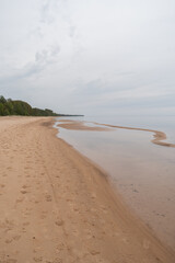 Sandy beach of  Baltic sea in cloudy and calm spring morning
