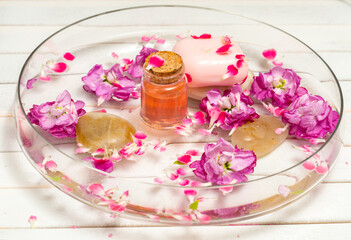 pink flowers and petals in a water in a glass bowl