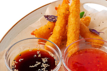 Deep fried shrimps served with sauce on plate
