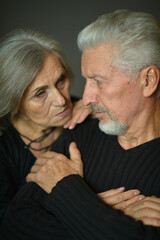 Portrait of sad senior couple posing at home