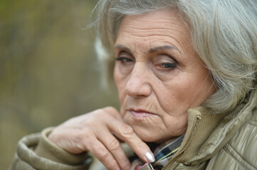 sad senior woman in  park