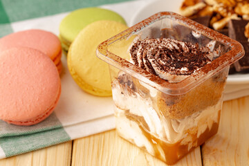 Mousse dessert with chocolate on wooden background