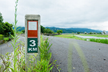Kilometer sign on the bicycle lane by the river
