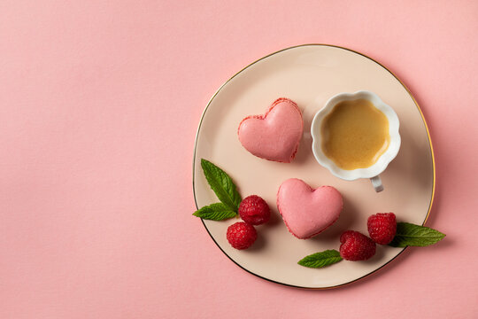 Romantic setup with coffee and heart shaped macarons