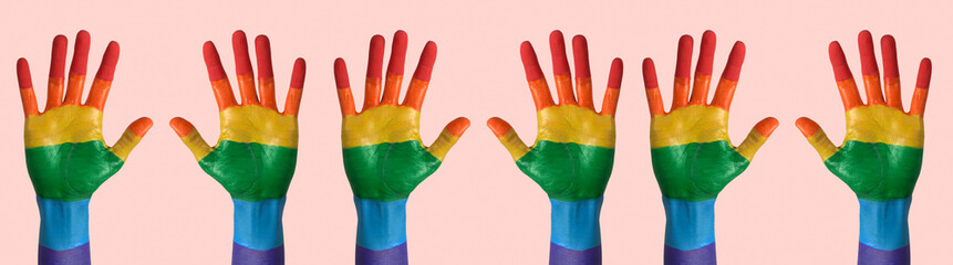 raised hands painted as the gay pride flag, banner