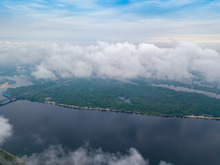 High view of the Dnieper River in Kiev through the clouds. Spring cloudy morning. Aerial high view.