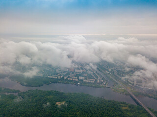 High view of the Dnieper River in Kiev through the clouds. Spring cloudy morning. Aerial high view.