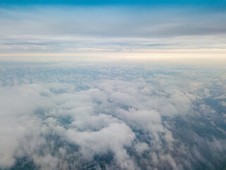 Fototapeta na wymiar High flight above the clouds in Kiev. Spring cloudy morning. Aerial high view.