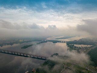 High view of the Dnieper River in Kiev through the clouds. Spring cloudy morning. Aerial high view.