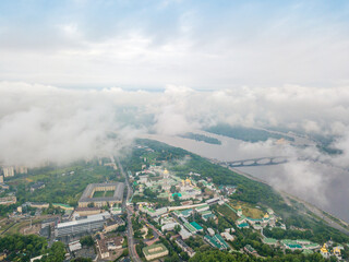 High view of the Dnieper River in Kiev through the clouds. Spring cloudy morning. Aerial high view.