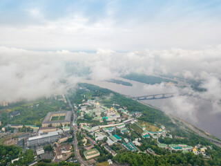 High view of the Dnieper River in Kiev through the clouds. Spring cloudy morning. Aerial high view.