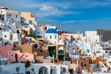 Tourist crowd in a viewpoint in Oia Village, Santorini island, Greece