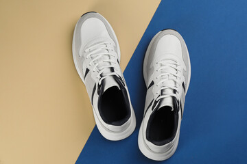 Pair of stylish sneakers on color background, flat lay