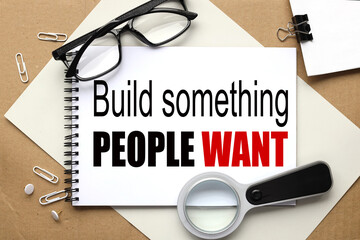 Build something people want.text on white notepad on craft background