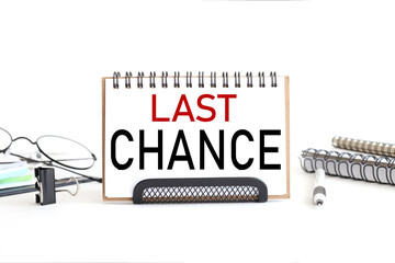 Last chance. text on notepad. on a white background near the stationery