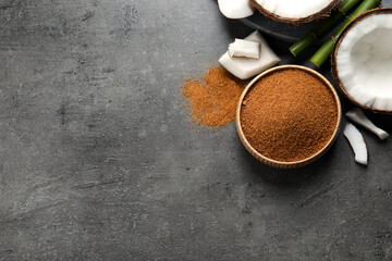 Flat lay composition with natural coconut sugar on grey table, space for text
