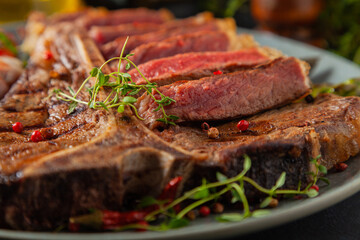 Grilled, medium-baked t-bone beef steak. Served with asparagus.