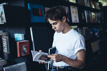 Thoughtful male reading notes in notebook