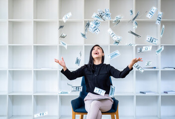 Young happy woman winner throwing money banknotes, working from home throwing money over her head....