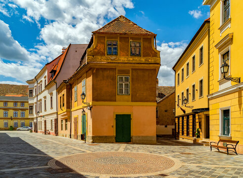 Cobblestone street and square with old houses in downtown of Gyor, Hungary. 