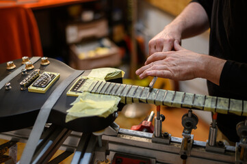 Black electrical guitar in repair service shop