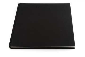 Black book lying on white surface