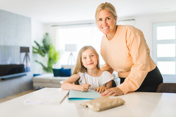 Mom helping kid with homework at home